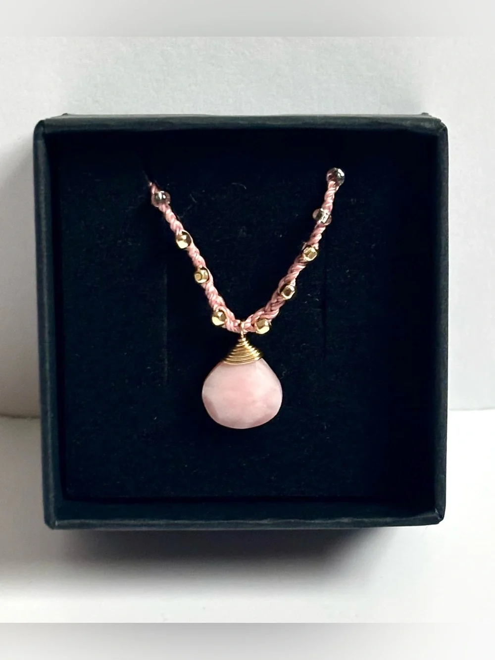 Pink silk thread necklace with a beautiful pink coral briolette stone